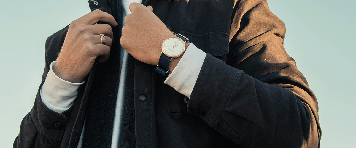 Image of a man in a suit showing his watch